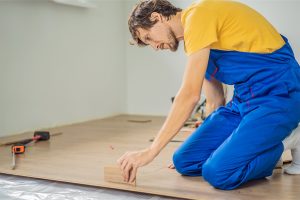 A technician installing a wood floor