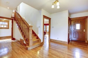 newly updated wood staircase in home with beautiful hardwood flooring