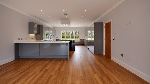 a modern style kitchen and dining space with hardwood floor